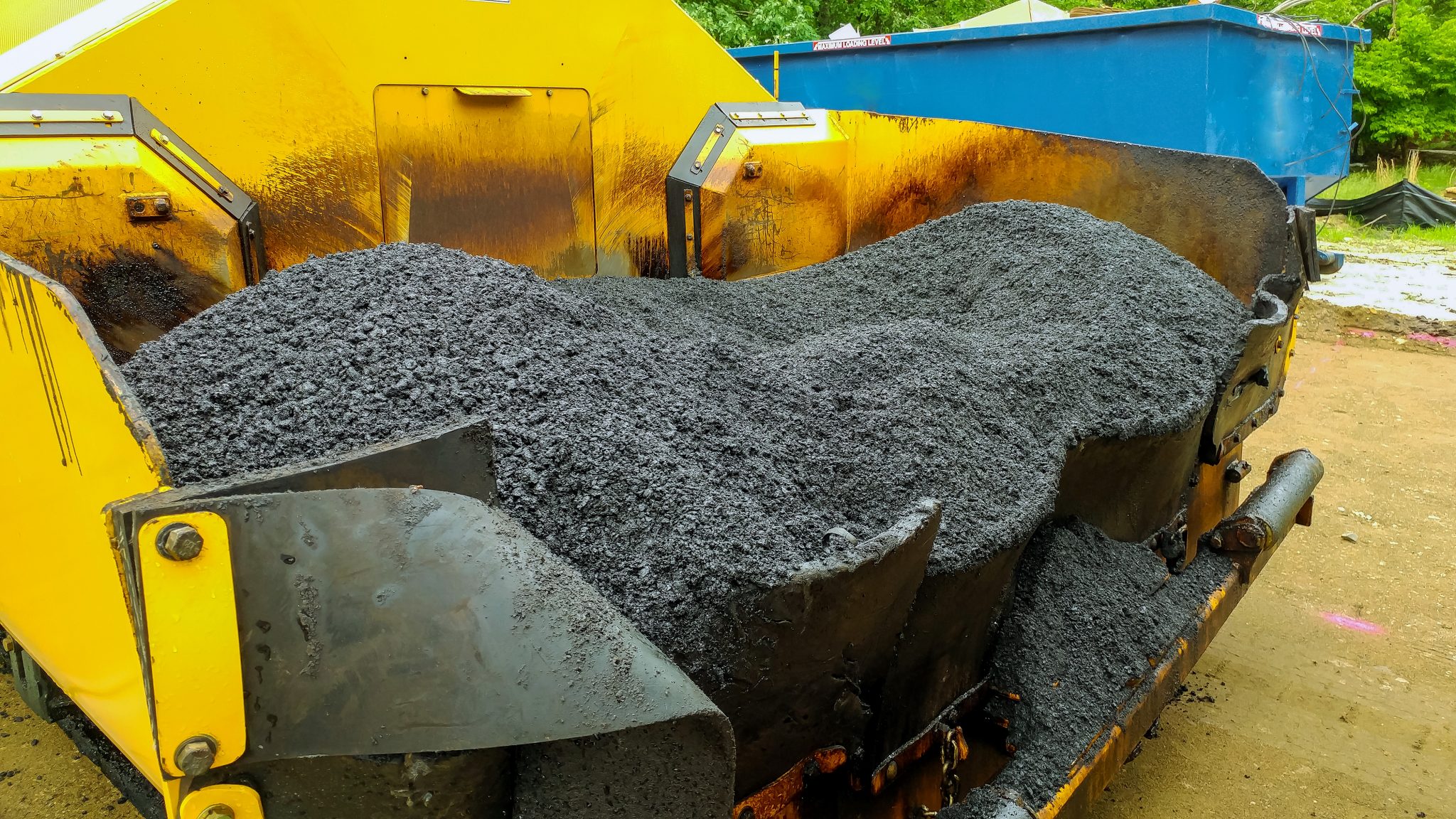 Asphalting paver machine during Road street repairing works machinery and power industrial tools.